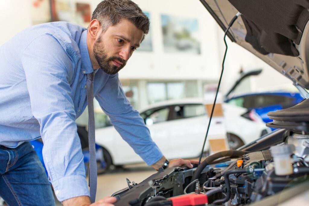 image of a man looking at his engine