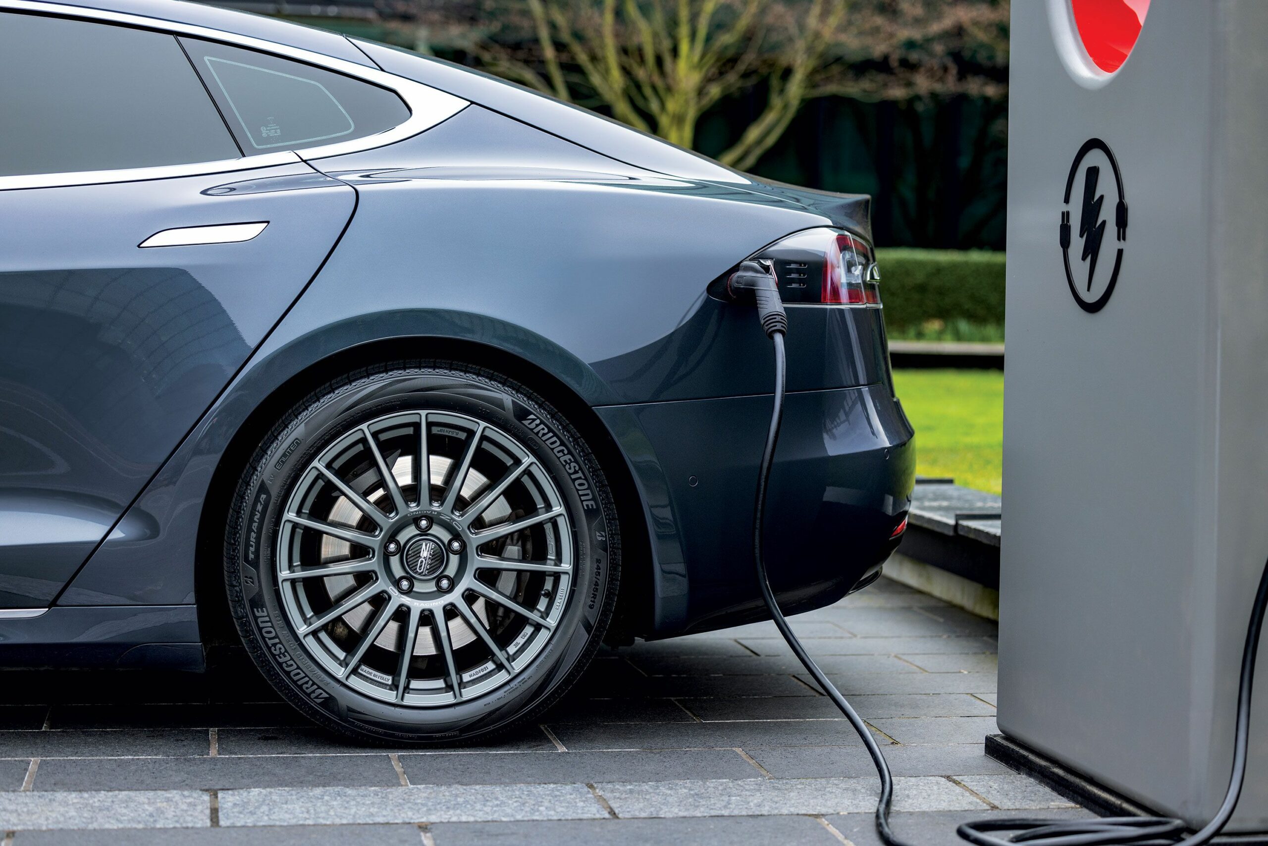 EV car tires parked by charging station