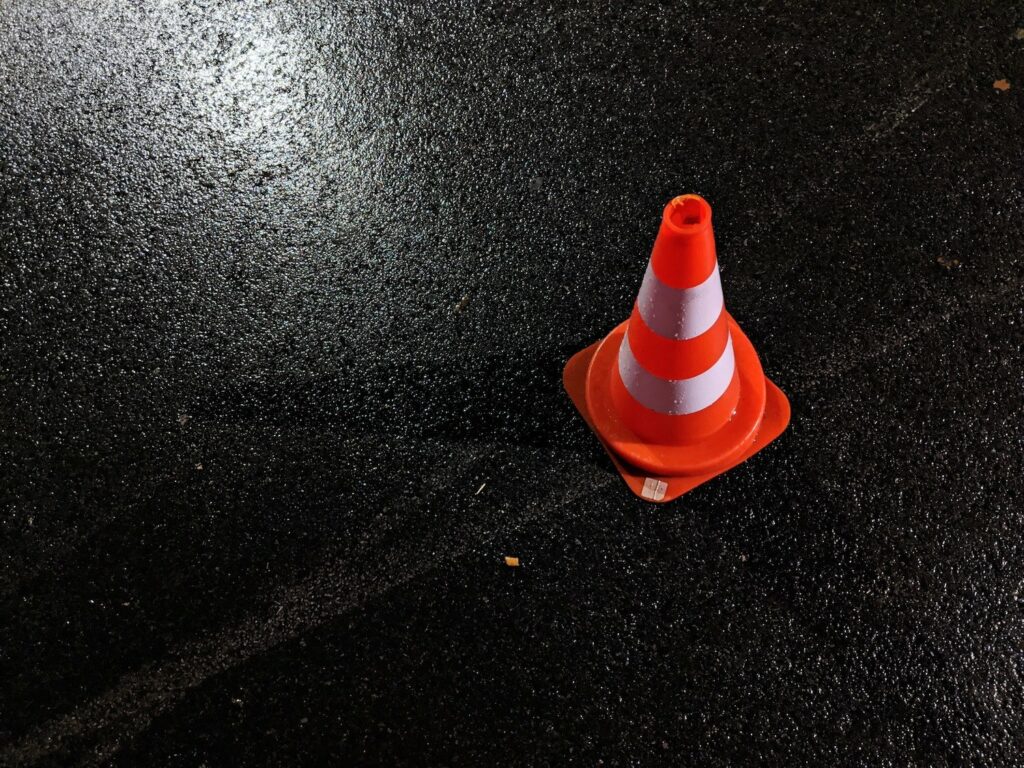 orange cone in parking lot for road test