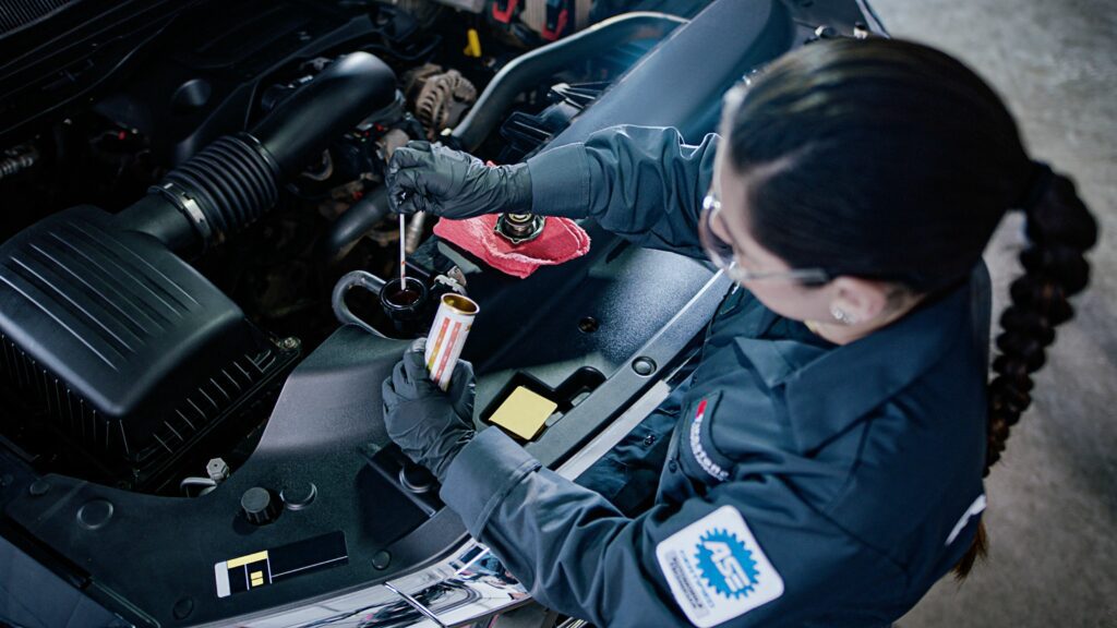 Mechanic checking a car's A/C system.