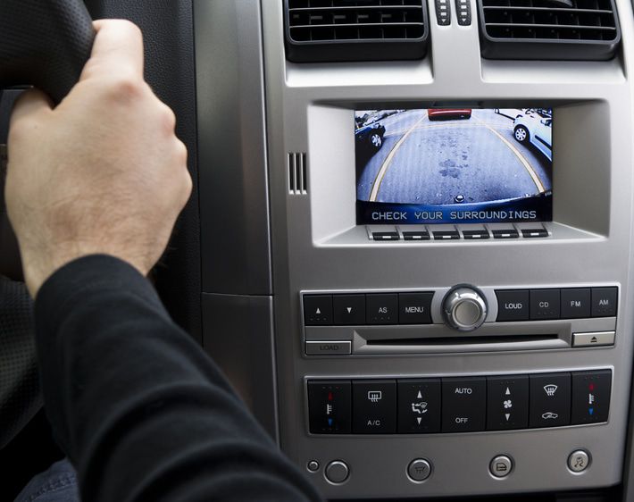 Car dashboard with screen showing rear camera picture