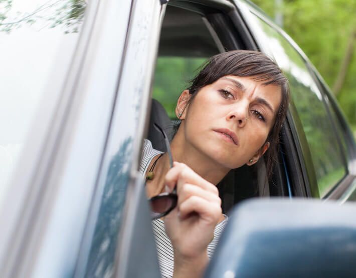 Driver concerned about bad shock symptoms, looking out her window