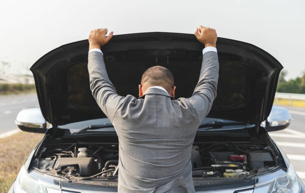 Man checking engine for noise