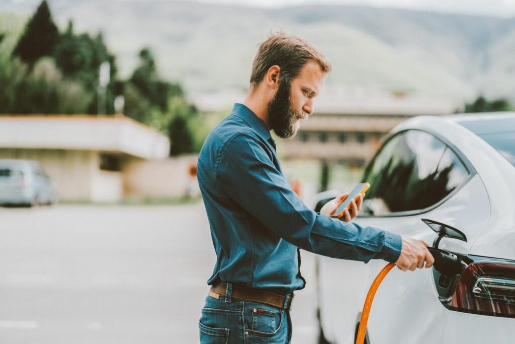 Man charging hybrid vehicle