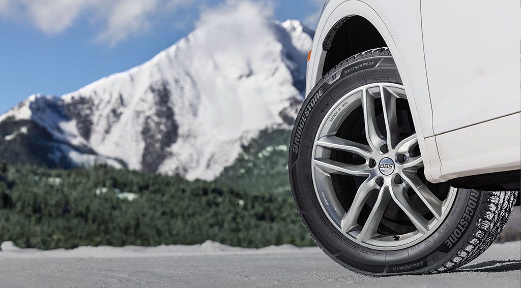 image of winter tires on a white car