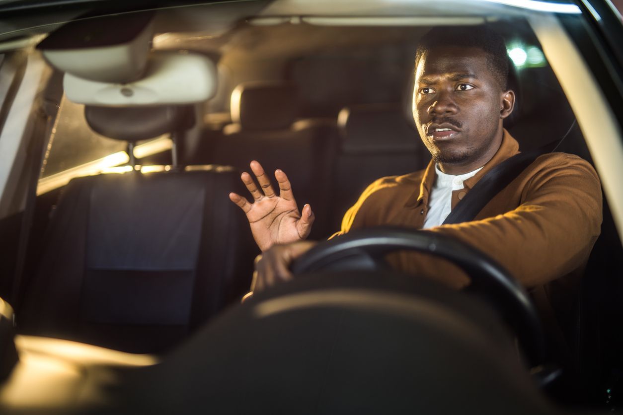 Hands gripping a steering wheel