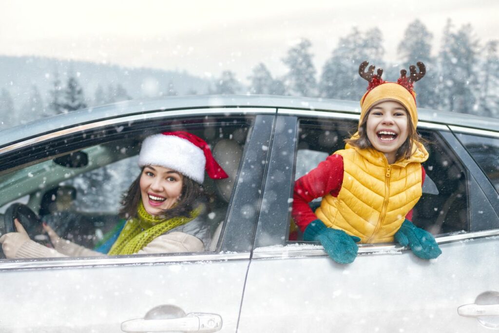 image of mom and daughter driving during the holidays