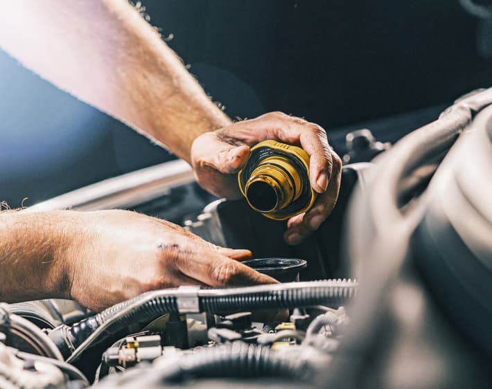 Person Checking Oil Tank Under Hood